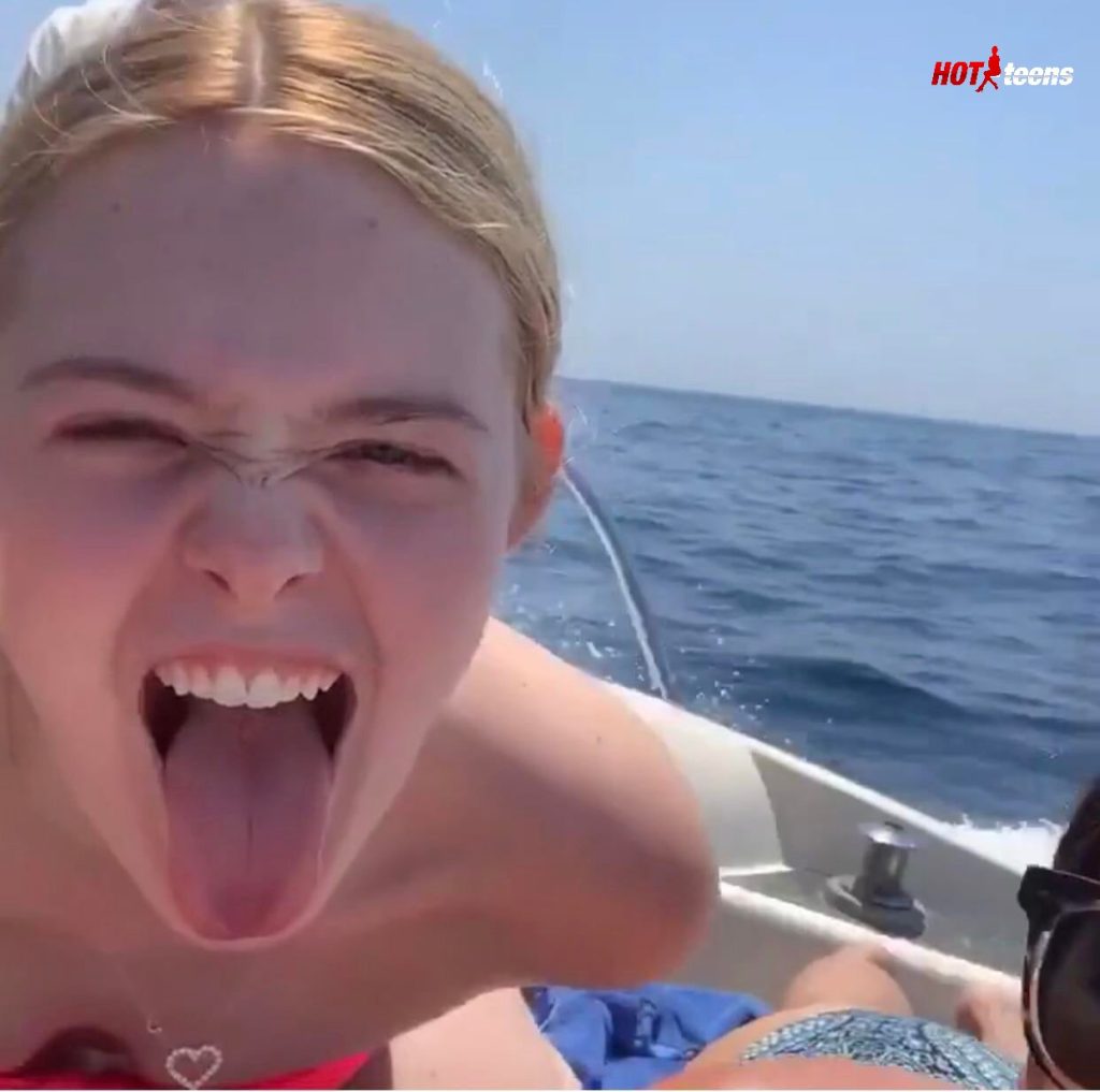 Elle Fanning tongue out on boat trip