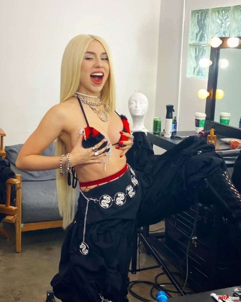 Ava Max holding her own boobs