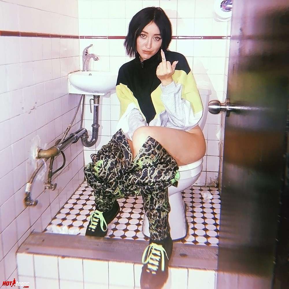 Nude ass of Noah Cyrus sitting on toilet