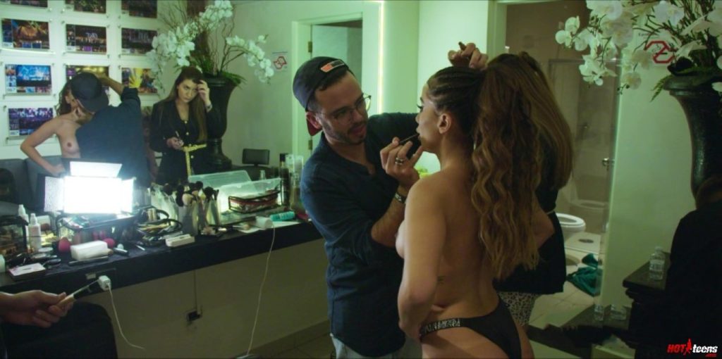 Anitta topless while doing make-up